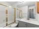 Neat bathroom with a white vanity, mirror, tiled shower featuring a gold frame, offering a fresh and functional space at 1699 S Trenton St # 174, Denver, CO 80231