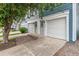 Inviting townhouse showcasing a clean white garage door, well-manicured landscaping, and a welcoming entrance at 1699 S Trenton St # 174, Denver, CO 80231