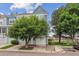 Attractive townhouse featuring a blue exterior, mature trees, and an attached garage in a desirable neighborhood at 1699 S Trenton St # 174, Denver, CO 80231
