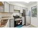 Modern kitchen featuring gray cabinetry, stainless steel appliances, and neutral countertops, offering a clean and contemporary space at 1699 S Trenton St # 174, Denver, CO 80231