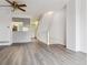 Spacious living area with hardwood floors, a ceiling fan, an adjacent kitchen, and access to the staircase at 1699 S Trenton St # 174, Denver, CO 80231