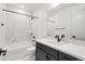 Modern bathroom features marble tile surround, soaking tub, and sleek black fixtures at 11383 Autumn Moon St, Littleton, CO 80125