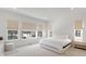Bright bedroom features large windows, neutral tones, and comfortable furnishings at 11383 Autumn Moon St, Littleton, CO 80125