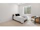 Bright bedroom with natural light from egress window and neutral decor with side chair at 11383 Autumn Moon St, Littleton, CO 80125