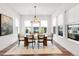 Elegant dining room with large windows, a chandelier, and seating for six at 11383 Autumn Moon St, Littleton, CO 80125