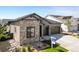 Gray home showcases stone facade, tidy xeriscaping, lawn, and dark trim at 11383 Autumn Moon St, Littleton, CO 80125