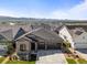 A lovely gray two-story home features a stone accent wall and a two-car garage at 11383 Autumn Moon St, Littleton, CO 80125