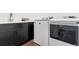 Updated laundry room boasts side by side washer and dryer with built-in sink and ample cabinets at 11383 Autumn Moon St, Littleton, CO 80125