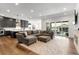 Spacious living room with open concept to the kitchen and hardwood floors at 11383 Autumn Moon St, Littleton, CO 80125