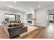 Bright living room with a modern fireplace, hardwood floors, and comfortable seating at 11383 Autumn Moon St, Littleton, CO 80125