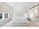 A serene bedroom offers bright natural light and a sliding barn door to ensuite at 11383 Autumn Moon St, Littleton, CO 80125