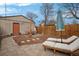 Private backyard with a stone patio, lounge chairs, and an outdoor dining area at 421 Elati St, Denver, CO 80204