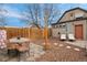 Private backyard featuring a dining area, a pair of chairs, and a string of lights for entertaining at 421 Elati St, Denver, CO 80204
