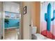 Cozy bathroom showcases a charming cactus-themed shower curtain and view of office beyond doorway at 421 Elati St, Denver, CO 80204
