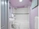 Bathroom featuring a tub with white tile surround, hexagon floor tiles, and lavender colored walls at 421 Elati St, Denver, CO 80204