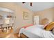 Comfortable bedroom with light hardwood floors, neutral walls and connecting dining area at 421 Elati St, Denver, CO 80204