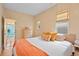 Bright bedroom featuring multiple windows, light hardwood floors and access to the adjacent office at 421 Elati St, Denver, CO 80204