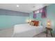 This bedroom is painted light blue and has a window, stylish lamps, and a comfortable bed at 421 Elati St, Denver, CO 80204