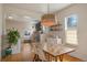 Elegant dining room with a large table, modern light fixture, and view of living room at 421 Elati St, Denver, CO 80204