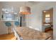 Open dining area with herringbone table, stylish lighting, and views to the kitchen at 421 Elati St, Denver, CO 80204