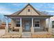 Charming home exterior with a porch swing and colorful accents at 421 Elati St, Denver, CO 80204