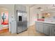 Kitchen with stainless steel refrigerator, light grey cabinets, and a view into another room at 421 Elati St, Denver, CO 80204