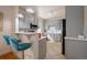 Kitchen with pendant lights, breakfast bar, and ample gray cabinets and tile flooring at 421 Elati St, Denver, CO 80204