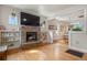 Open-concept living room with a stone fireplace, built-in shelving, and hardwood floors at 421 Elati St, Denver, CO 80204