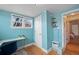 Bright office featuring light hardwood floors, built-in shelving and a window with neighborhood views at 421 Elati St, Denver, CO 80204