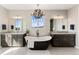 Bathroom featuring dual sinks, a standalone tub and chandelier at 3128 Bivouac Pt, Castle Rock, CO 80108