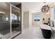 Bathroom with glass shower, standalone tub, and decorative chandelier at 3128 Bivouac Pt, Castle Rock, CO 80108