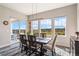 Inviting dining area with contemporary lighting, large windows, and beautiful outdoor view at 3128 Bivouac Pt, Castle Rock, CO 80108