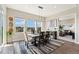 Bright dining room with large windows offering scenic views and stylish decor at 3128 Bivouac Pt, Castle Rock, CO 80108