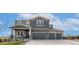 Beautiful two-story home featuring a three-car garage and charming stone accents on the facade at 3128 Bivouac Pt, Castle Rock, CO 80108