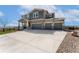 View of the house with a three-car garage and a driveway with space for additional parking at 3128 Bivouac Pt, Castle Rock, CO 80108