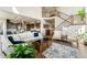Open-concept living area featuring a grand staircase, neutral tones, and access to the kitchen at 3128 Bivouac Pt, Castle Rock, CO 80108
