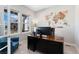 Inviting office with large windows, custom wood-carved map, and a comfortable seating area at 3128 Bivouac Pt, Castle Rock, CO 80108