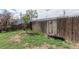 Backyard with wood fence, green grass, plants, and garden decor at 4849 Lincoln St, Denver, CO 80216