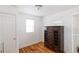 Bedroom featuring hardwood floors, a dresser and two windows allowing for natural light at 4849 Lincoln St, Denver, CO 80216