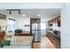Bright kitchen with stainless steel appliances, granite counters and ample cabinetry at 4849 Lincoln St, Denver, CO 80216