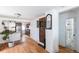 Open living space with hardwood floors leading to the kitchen and bathroom at 4849 Lincoln St, Denver, CO 80216