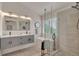 Spa-like bathroom features dual vanity, soaking tub, and glass-enclosed shower with sleek modern design at 9884 Sydney Ln, Highlands Ranch, CO 80130