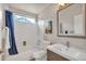 Full bathroom featuring shower-tub combination, modern vanity, and a large mirror reflecting natural light at 9884 Sydney Ln, Highlands Ranch, CO 80130