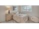 Bright bedroom featuring a comfortable bed, dresser, and a view to outside from the window at 9884 Sydney Ln, Highlands Ranch, CO 80130