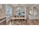 Inviting dining room features a glass table, tufted bench, and views of the community at 9884 Sydney Ln, Highlands Ranch, CO 80130