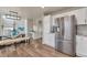 Open-concept dining room with a glass-top table, bench seating, and modern light fixture at 9884 Sydney Ln, Highlands Ranch, CO 80130