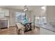 Dining room area featuring glass table, upholstered seating, and modern light fixture at 9884 Sydney Ln, Highlands Ranch, CO 80130