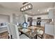 Open-concept dining area connecting to kitchen, featuring modern table setting at 9884 Sydney Ln, Highlands Ranch, CO 80130