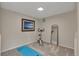Bright exercise room with carpet, mirror, exercise bike, and artwork at 9884 Sydney Ln, Highlands Ranch, CO 80130