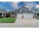 Charming two-story home with a well-manicured lawn, two car garage and inviting front porch at 9884 Sydney Ln, Highlands Ranch, CO 80130